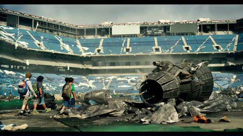 Kids walking through damaged Football Stadium